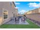 The backyard offers a patio area with outdoor seating and manicured landscaping features at 958 Harbor Ave, Henderson, NV 89002