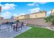 Backyard with a patio seating area, artificial grass, and a privacy wall at 958 Harbor Ave, Henderson, NV 89002