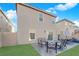 Backyard featuring a patio with outdoor seating and a view of the home's exterior at 958 Harbor Ave, Henderson, NV 89002
