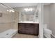 Bright bathroom featuring double sinks, walk-in shower, and neutral wall color at 958 Harbor Ave, Henderson, NV 89002
