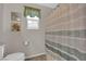Bathroom featuring a toilet, decorative artwork, and a striped shower curtain at 958 Harbor Ave, Henderson, NV 89002