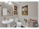 Charming powder room with pedestal sink, decorative mirror, and neutral walls at 958 Harbor Ave, Henderson, NV 89002