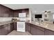 Kitchen featuring granite countertops, modern appliances, and dark wood cabinetry at 958 Harbor Ave, Henderson, NV 89002