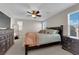 This main bedroom is spacious and features a ceiling fan and dark furniture at 958 Harbor Ave, Henderson, NV 89002