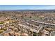 Expansive aerial view of a desert community featuring many single-Gathering homes, a golf course, and distant city views at 9816 Gerald Ct, Las Vegas, NV 89134