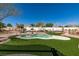 Backyard featuring turf, a pool, and desert landscaping at 9816 Gerald Ct, Las Vegas, NV 89134