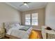 Cozy bedroom with natural light, ceiling fan, and hardwood floors at 9816 Gerald Ct, Las Vegas, NV 89134