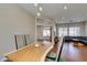 Dining room has hardwood floors, a live-edge table and modern chairs with an opening to a living room at 9816 Gerald Ct, Las Vegas, NV 89134