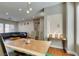 Open-concept dining area featuring a rustic wood table and view of a cozy living space at 9816 Gerald Ct, Las Vegas, NV 89134