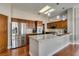 Well-lit kitchen with stainless steel refrigerator and large island with granite countertop at 9816 Gerald Ct, Las Vegas, NV 89134
