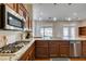 View of kitchen with granite counters and stainless steel appliances looking towards the dining area at 9816 Gerald Ct, Las Vegas, NV 89134