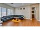 Bright living room featuring wood floors, a modern sectional, recessed lights, and neutral wall paint at 9816 Gerald Ct, Las Vegas, NV 89134
