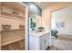 Bathroom featuring a vanity with a sink, a mirror, and a walk-in closet at 1409 Brady Bay Pl # 110, North Las Vegas, NV 89084