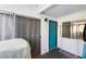 The image shows an outdoor balcony with a blue front door, sliding glass doors, and clothes rack at 1455 E Katie Ave # A21, Las Vegas, NV 89119