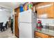 Bright kitchen featuring a white refrigerator and a view into an adjacent dining space at 1455 E Katie Ave # A21, Las Vegas, NV 89119