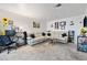 Image shows a bright and spacious living room with a large sectional couch and office area at 1455 E Katie Ave # A21, Las Vegas, NV 89119