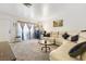 Image shows a well-lit living room with a white sectional couch and carpet at 1455 E Katie Ave # A21, Las Vegas, NV 89119