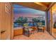 Balcony with two chairs, a table and nice views of the city and surrounding nature at 210 E Flamingo Rd # 326, Las Vegas, NV 89169