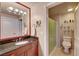 Well-lit bathroom with a granite countertop vanity and a shower with glass door at 210 E Flamingo Rd # 326, Las Vegas, NV 89169