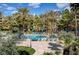 An elevated view of the community pool with shade umbrellas and lounge chairs at 210 E Flamingo Rd # 326, Las Vegas, NV 89169
