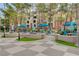 Relaxing community courtyard with outdoor dining areas and blue shade umbrellas at 210 E Flamingo Rd # 326, Las Vegas, NV 89169