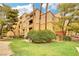 Low angle view of a 3-story condo building with balcony, lawn and landscaping at 210 E Flamingo Rd # 326, Las Vegas, NV 89169