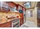 Well-equipped kitchen with stainless steel appliances, granite countertops, and warm, dark wood cabinetry at 210 E Flamingo Rd # 326, Las Vegas, NV 89169