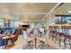 Open-concept living and dining area boasts a mirrored wall, glass-top table with seating, and access to the kitchen at 210 E Flamingo Rd # 326, Las Vegas, NV 89169