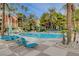 Relax by the sparkling pool with comfortable lounge chairs, surrounded by lush landscaping and palm trees at 210 E Flamingo Rd # 326, Las Vegas, NV 89169