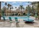 Resort-style pool area with lounge chairs, umbrellas, and beautifully landscaped grounds perfect for relaxation and recreation at 210 E Flamingo Rd # 326, Las Vegas, NV 89169