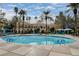 Beautiful community pool featuring clear blue water, comfortable seating, and a charming building backdrop at 210 E Flamingo Rd # 326, Las Vegas, NV 89169