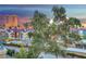 Sunset view of the Las Vegas skyline with mature trees in the foreground at 210 E Flamingo Rd # 326, Las Vegas, NV 89169