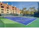 Enjoy a match on this pristine blue tennis court with lush landscaping and luxury condos in the background at 210 E Flamingo Rd # 326, Las Vegas, NV 89169