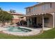 Backyard featuring a pool with a blue tile border, an outdoor kitchen, and a covered patio at 2199 Maple Shade St, Henderson, NV 89002