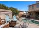 Backyard pool area with a fire pit, seating, and a shed, perfect for entertaining at 2199 Maple Shade St, Henderson, NV 89002