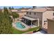 Relax in this backyard with a refreshing pool, covered patio and lush artificial turf at 2199 Maple Shade St, Henderson, NV 89002