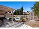 Backyard featuring a covered patio, a pool, a shed, and rock landscaping at 2199 Maple Shade St, Henderson, NV 89002
