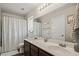 Bathroom featuring double sinks, a vanity, and a decorative shower curtain in a bright space at 2199 Maple Shade St, Henderson, NV 89002