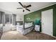 Bedroom featuring a modern ceiling fan, a green accent wall, and a window with natural light at 2199 Maple Shade St, Henderson, NV 89002