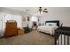 Comfortable bedroom with a ceiling fan, crib, bed, and a window offering natural light at 2199 Maple Shade St, Henderson, NV 89002