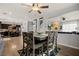 Open dining area with wood table and chairs, ceiling fan, and hardwood floors at 2199 Maple Shade St, Henderson, NV 89002
