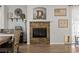 Elegant dining area with a stone fireplace, a rustic table, and a modern light fixture at 2199 Maple Shade St, Henderson, NV 89002
