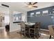 Stylish dining room with modern chairs, an accent wall, and an adjacent living area at 2199 Maple Shade St, Henderson, NV 89002