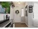 Inviting entryway featuring wood-look floors, decorative wreath, and stylish decor at 2199 Maple Shade St, Henderson, NV 89002