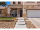 Charming home with a well-manicured lawn, concrete walkway, and two-car garage at 2199 Maple Shade St, Henderson, NV 89002
