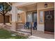 Inviting covered front porch with seating area and decorative wreath on the front door at 2199 Maple Shade St, Henderson, NV 89002