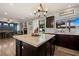 Open concept kitchen with center island, modern appliances, and backyard view at 2199 Maple Shade St, Henderson, NV 89002