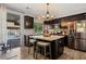 Updated kitchen with island, dark wood cabinets, and sliding doors leading to a pool area at 2199 Maple Shade St, Henderson, NV 89002