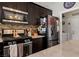 Kitchen with stainless steel appliances, decorative backsplash, and view into the laundry room at 2199 Maple Shade St, Henderson, NV 89002
