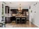 Modern kitchen features stainless steel appliances, an island, and dark cabinetry at 2199 Maple Shade St, Henderson, NV 89002